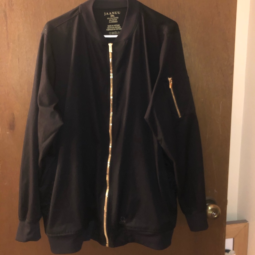 Jaanuu black scrub jacket with gold zippers